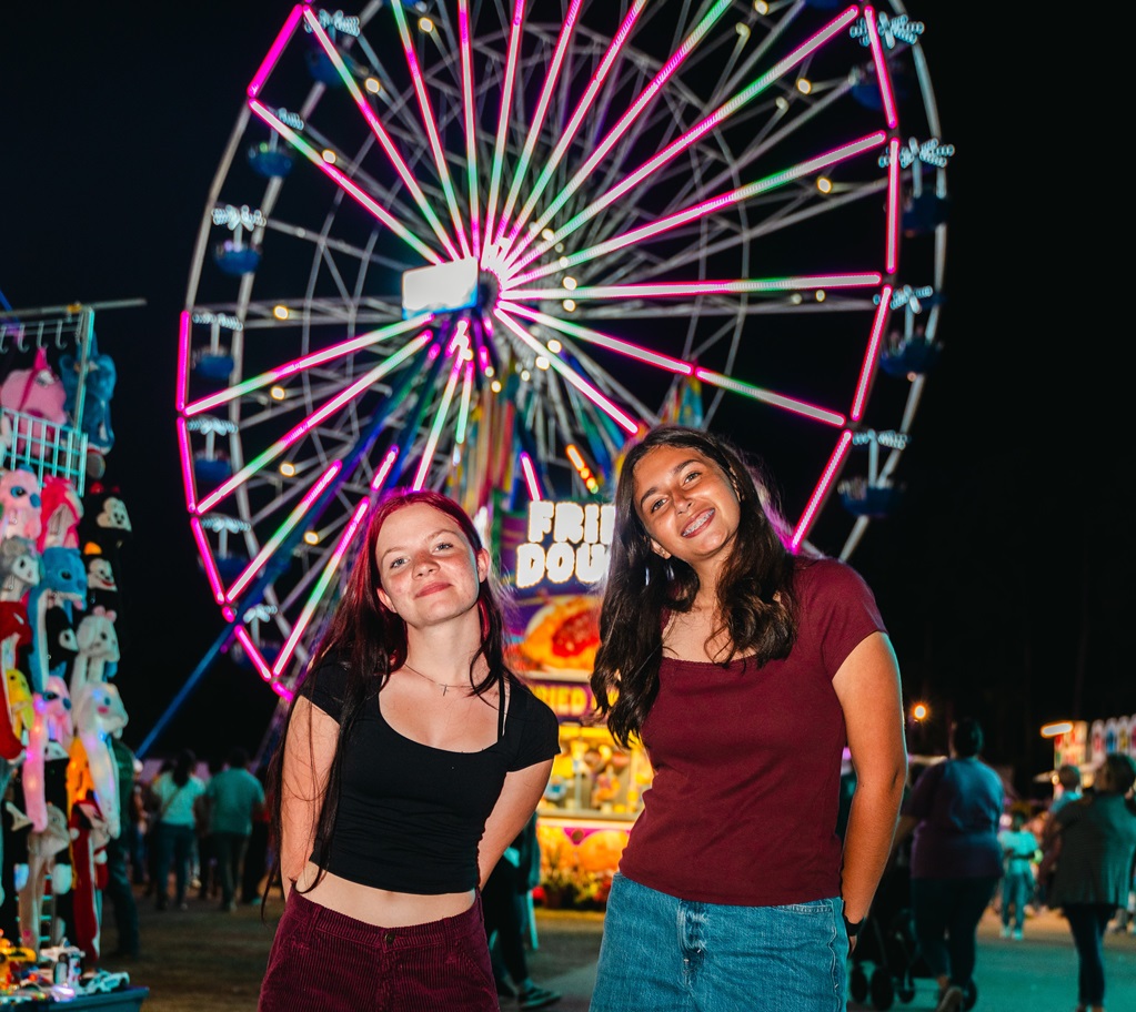 Two girls in front of Ferris Wheel